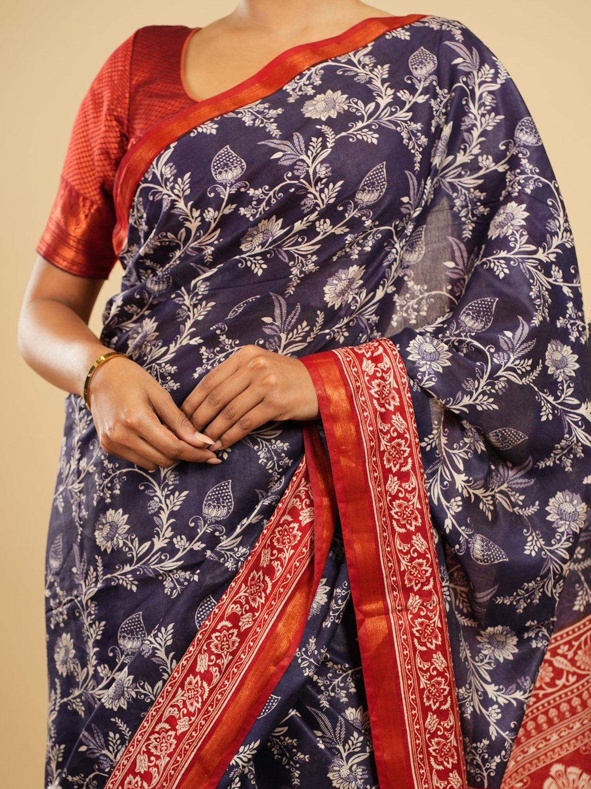 Navy Modal saree with red border, draped full-length and pinned at the shoulder — Koshnika