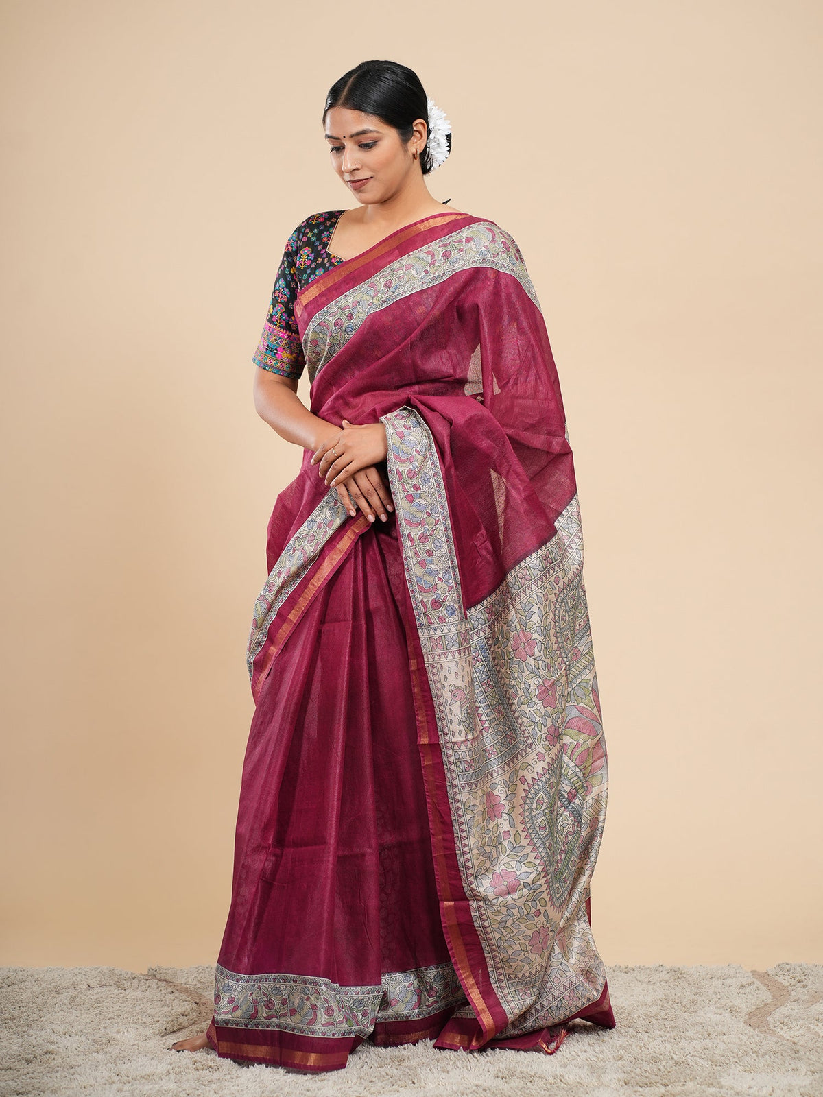 Deep maroon vegan silk saree in viscose, draped to show the fall and Madhubani-inspired border — Koshnika