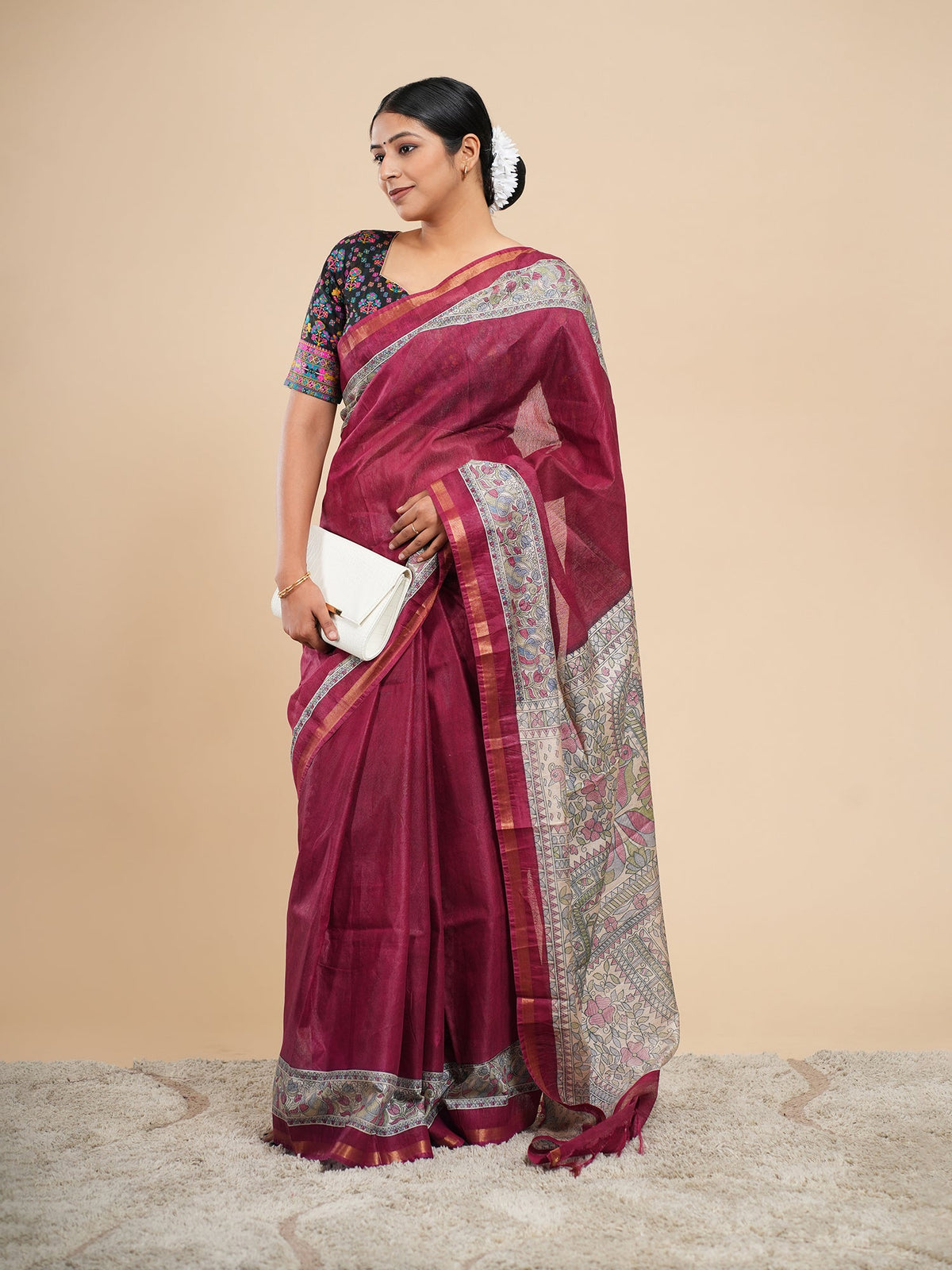 Deep maroon viscose saree draped full length with a cream Madhubani-inspired border, showing the soft fall that separates a viscose saree from pure silk — Koshnika