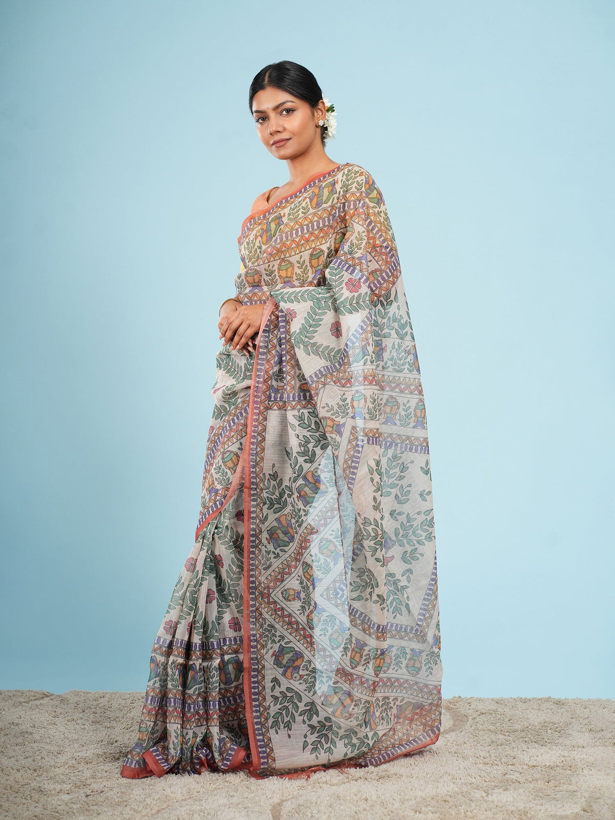 Rust Tussar silk saree draped full-length, a natural fabric in the natural vs synthetic saree fabrics guide — Koshnika